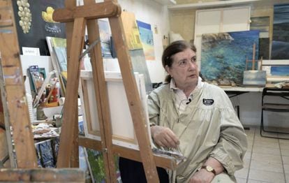 Retired translator Ute Rebholz paints a canvas.