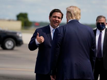 Ron DeSantis talks to Donald Trump at the Fort Myers airport in Florida in October 2020, weeks before the last presidential election.
