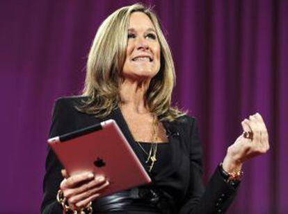 Angela Ahrendts speaks as she holds an iPad at the 2011 World Business Forum in New York.
