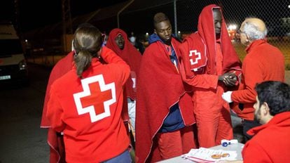 Red Cross staff tend to immigrants rescued from a dinghy in Motril.