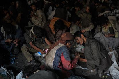 With hardly any room to move, hundreds of men take drugs under Kabul's Pul-e-Sukhta Bridge.