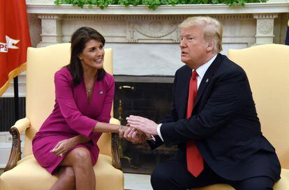 In this file photo taken on October 09, 2018, US President Donald Trump shakes hands with Nikki Haley, the United States Ambassador to the United Nations, in the Oval Office of the White House.