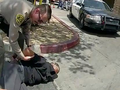 In this image taken from police body camera provided by Los Angeles Sheriff's office on June 24, 2023, a  Sheriff's deputy arrests a couple in a grocery store parking lot in Lancaster, California.