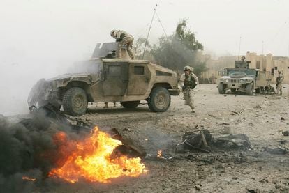 US soldiers next to an exploded car bomb in Abu Ghraib, April 3, 2005.