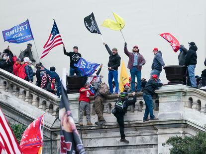Rioters wave flags on the West Front of the U.S. Capitol in Washington on Jan. 6, 2021.