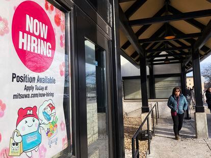 A hiring sign is displayed at a grocery store in Arlington Heights, Ill., on December 27, 2022.