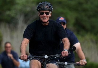 U.S. President Joe Biden rides his bike down a path in Gordons Pond State Park in Rehoboth Beach, Delaware, U.S., August 3, 2023.