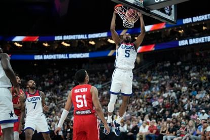 United States' Mikal Bridges (5) dunks over Puerto Rico's Tremont Waters (51) during the first half of an exhibition basketball game Monday, Aug. 7, 2023, in Las Vegas.