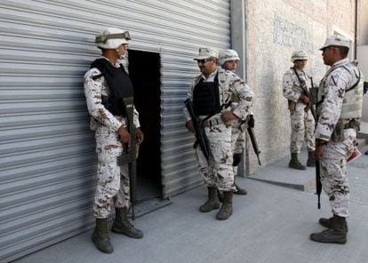 Soldiers guard the entrance of the warehouse where the secret tunnel was being constructed.