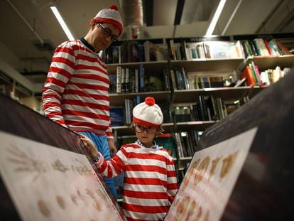 A man and a boy, dressed as the character Waldo, at an event in a London bookstore in September 2019.