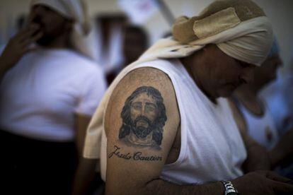 An image of Jesus the Captive tattooed on a man's arm in Seville on April 14, 2019.