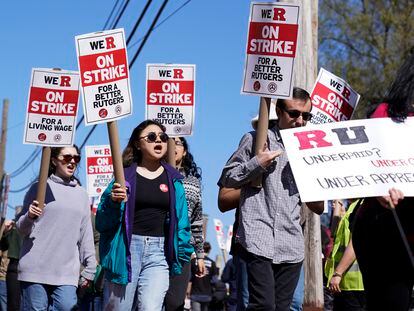 Strikers march in front of Rutgers' buildings in New Brunswick, New Jersey, on April 10, 2023.