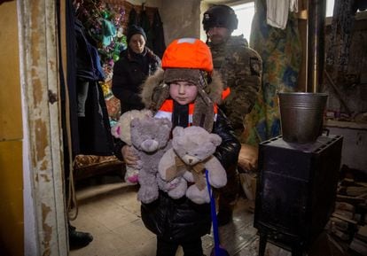 A girl, dressed in a life jacket, holds her stuffed animals before being evacuated from the city of Bakhmut on Tuesday.