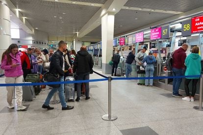 Queues of people waiting at check-in counters at Moscow airport on Wednesday.