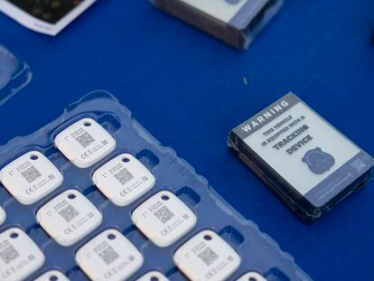 Mobile tracking devices from the Metropolitan Police Department are seen on a table during an event where police officers distributed Apple AirTags to drivers in Washington, Nov. 7, 2023.