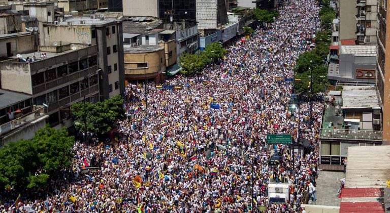 Thousands of people march on the streets of Caracas.