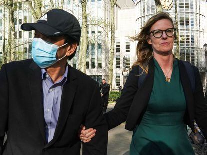 Lu Jianwang, one of two defendants accused of running a clandestine police station for the benefit of China, stands with his attorney Deirdre von Dornum as he leaves a federal courthouse in New York.
