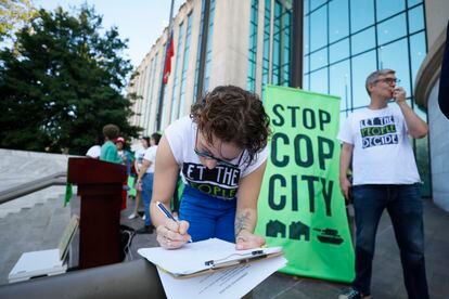 Activists gather outside Atlanta City Hall, Monday, Sept. 11, 2023, where they delivered dozens boxes full of signed petitions to force a referendum on the future of a planned police and firefighter training center