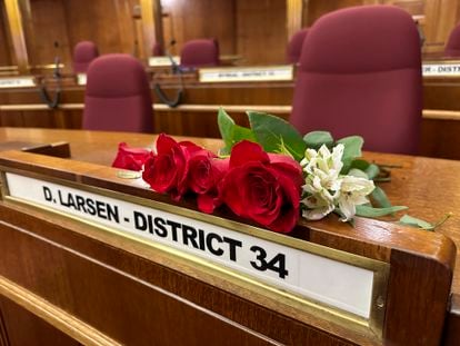 Roses rest on the Senate desk of late North Dakota Republican state Sen. Doug Larsen, at the state Capitol Monday, Oct. 2, 2023, in Bismarck, N.D. Larsen, his wife Amy, and their two young children died Sunday in a plane crash near Moab, Utah.