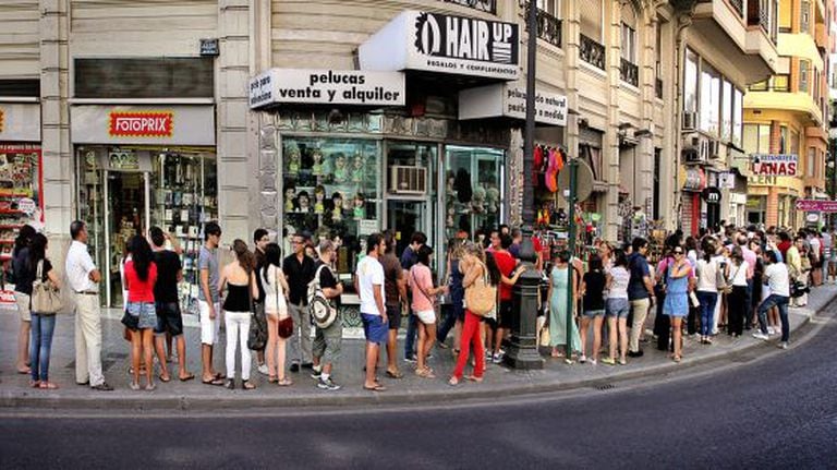 People in Valencia wait in line to sign up for German classes.