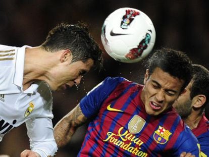 Cristiano Ronaldo (L) heads the ball next to Barcelona&#039;s Chiliean forward Alexis Sanchez (R) during the Spanish League &quot;El clasico.&quot;