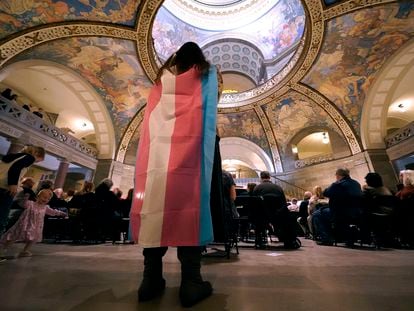 A protester wears a transgender flag as a counterprotest during a rally in favor of a ban on gender-affirming health care legislation, March 20, 2023, at the Missouri Statehouse in Jefferson City, Missouri.