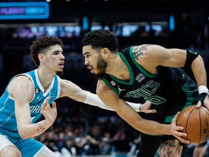 Boston Celtics forward Jayson Tatum, right, looks to drive against Charlotte Hornets guard LaMelo Ball during the second half of an NBA basketball game in Charlotte, N.C., Monday, Jan. 16, 2023.