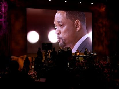 A tearful Will Smith is seen on a screen as he accepts his award for Best Actor.