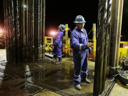 An operator works on an oil drill in Venezuela.