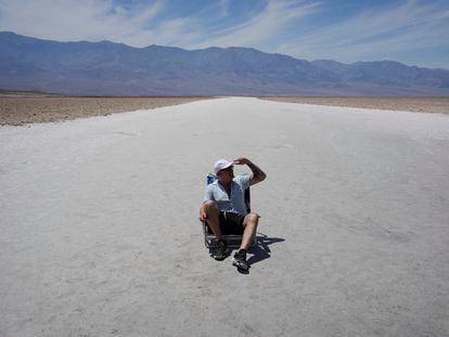 A Brazilian tourist sits on the Badwater salt flats in Death Valley National Park on July 16.