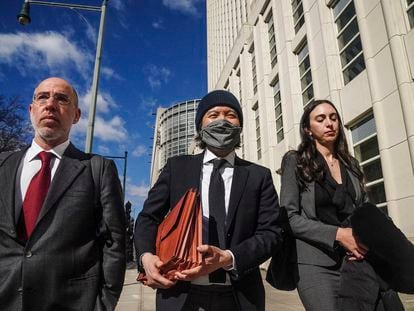 Roger Ng, center, leaves federal court with his lawyers after being sentenced to 10 years in prison on March 9, 2023, in New York.