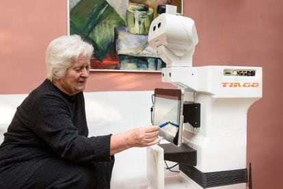 A woman interacts with the TIAGo robot from PAL Robotics, during a pilot project called EnrichMe