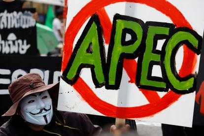 A demonstrator holds a sign during a protest against the Asia-Pacific Economic Cooperation APEC summit venue, Friday, Nov. 18, 2022, in Bangkok, Thailand.