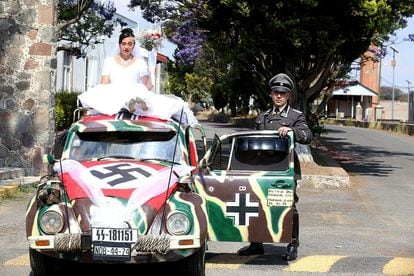 A couple next to the wedding float of a Nazi-themed wedding held on April 29 in Tlaxcala (Mexico).
