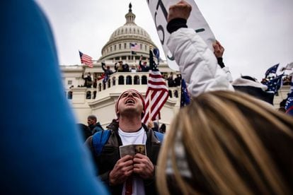 A man praying outside the Capitol at the time of the assault.