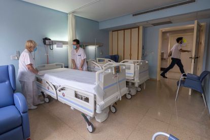 Two healthcare workers prepare a room in the Hospital Universitario Morales Meseguer in Murcia, after the last coronavirus patient there was discharged.