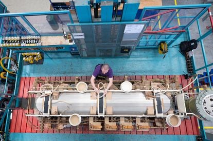 An operator works at a Siemens transformer factory in Dresden, Germany, in April 2023.