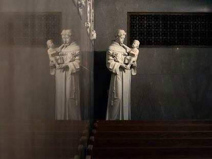 A statue of St. Anthony holding the infant Jesus is reflected in a wall in St. Aloysius Catholic Church, Friday, May 26, 2023, in Detroit.