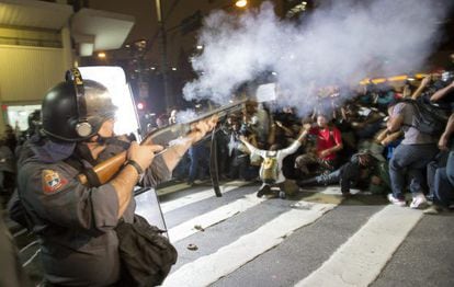 A police officer disperses a crowd of demonstrators in São Paulo.
