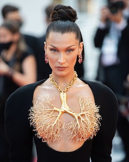 Bella Hadid astatine  the Cannes festival with a Schiaparelli nipple necklace.