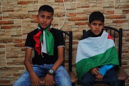Mohamed (14), left, and Musa (8), sons of Bilal Saleh (40), who was shot dead Saturday morning by a Jewish settler.