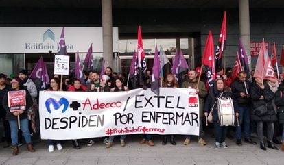 Extel workers at a protest with a sign that reads: “Fired for being sick.”