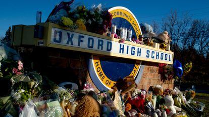 Family, friends, students, and relatives of victims put up bouquets of flowers, candles and personalized messages at a memorial near an entrance to the Oxford High School in 2021 in Oxford, Michigan.