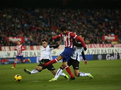 Valencia’s defenders bounce off Diego Costa last Sunday.
