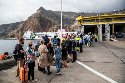 Passengers line up for a ferry after eruption forces La Palma airport to close.