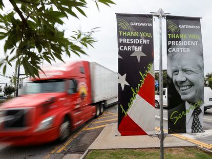 Motorists pass a sign dedicated to former President Jimmy Carter along Jimmy Carter Blvd. on Tuesday, May 23, 2023, in Norcross, Ga.