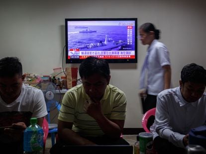 Taiwanese residents watch a news broadcast about a military drill conducted by the Chinese military around the Taiwan Strait, in Taipei, Taiwan, 19 August 2023.