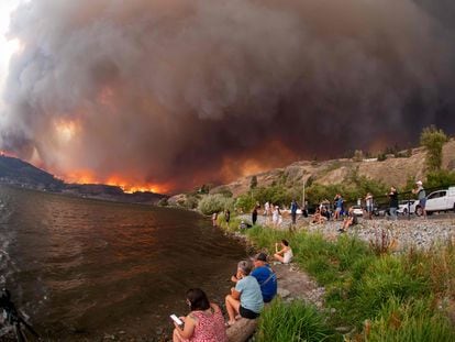 Residents stare at the McDougall Creek wildfire in West Kelowna, British Columbia, Canada, on August 17, 2023.