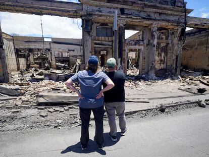 Hawaii Governor Josh Green, right, and FEMA Administrator Deanne Criswell look at a building destroyed by flames in Lahaina, the capital of Maui, Hawaii, on Saturday.