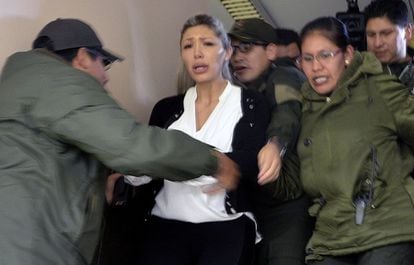 Gabriela Zapata is escorted from court on Sunday by police officers.